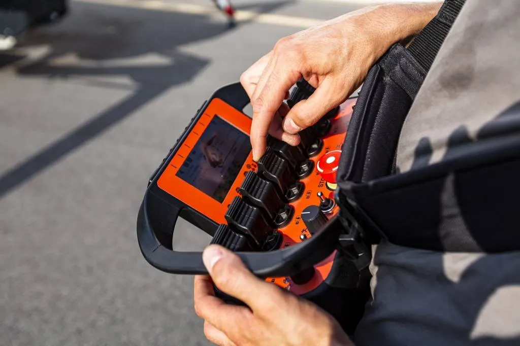 Operator holding the Jekko radio remote control