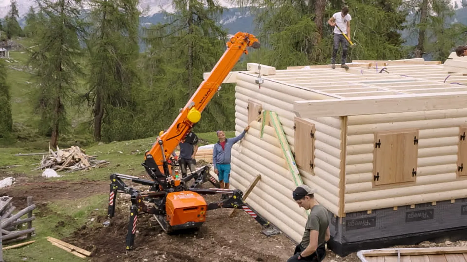SPX532.2 lifting a timber wall section into place on a log cabin build